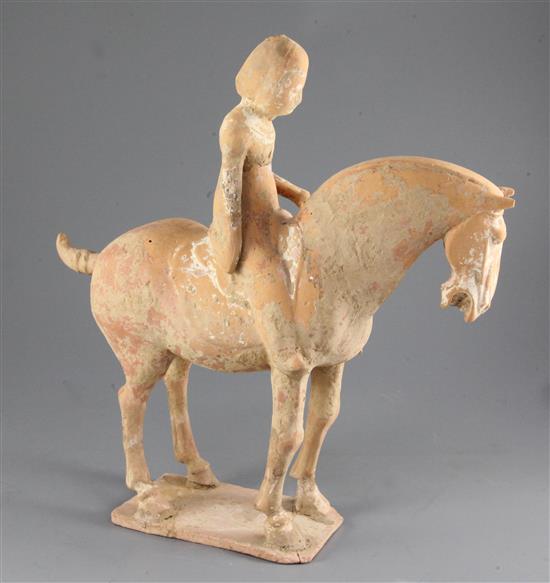 A Chinese polychrome painted pottery group of a horse and rider, Tang dynasty or later, height 36.5cm